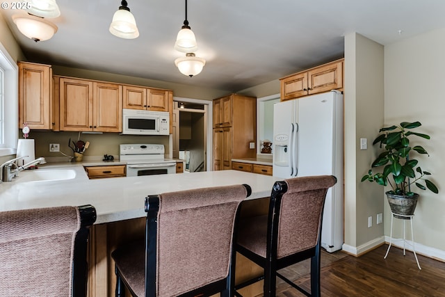 488 Pinto Way, Eugene, OR 97401 - kitchen with white appliances, a sink, a peninsula, dark wood finished floors, and light countertops