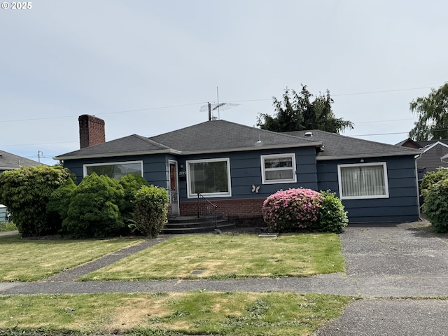 2727 Maple St, Longview, WA 98632 - bungalow-style house featuring a chimney, a front yard, and roof with shingles