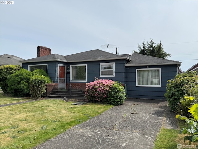 2727 Maple St, Longview, WA 98632 - bungalow-style house with a chimney, a front yard, and a shingled roof