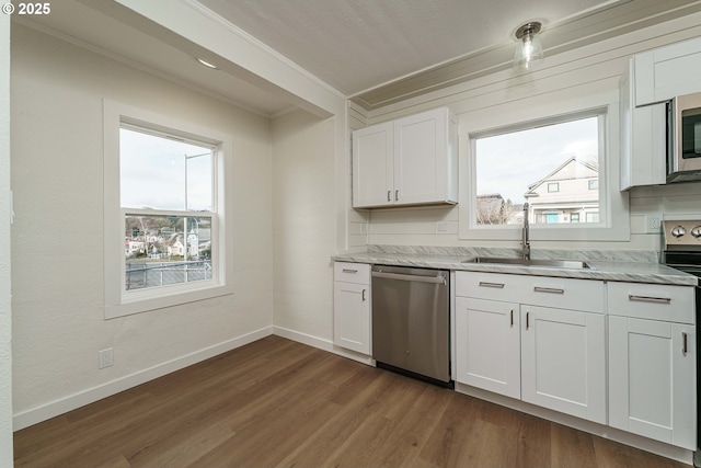 kitchen featuring white cabinetry, appliances with stainless steel finishes, dark wood-type flooring, and sink