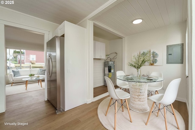 dining space featuring wooden ceiling, electric water heater, electric panel, and light hardwood / wood-style flooring