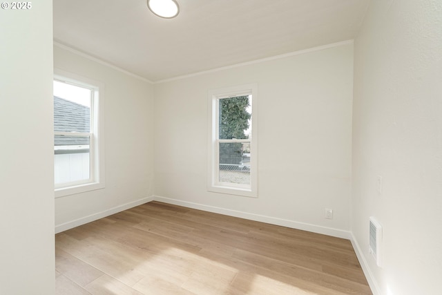 unfurnished room with crown molding and light hardwood / wood-style flooring