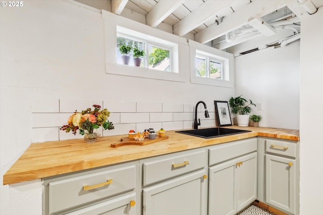 3330 SE 66th Ave, Portland, OR 97206 - kitchen with a sink, butcher block counters, decorative backsplash, and beam ceiling