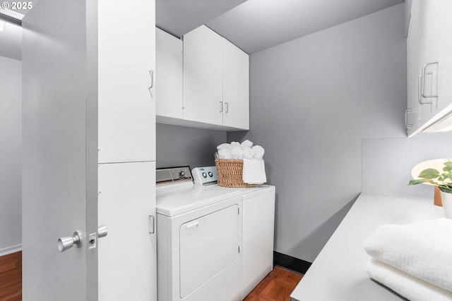 laundry area featuring parquet flooring, washing machine and dryer, and cabinets