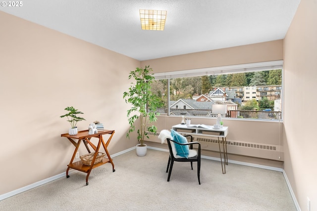 office space with carpet floors, radiator heating unit, and a textured ceiling