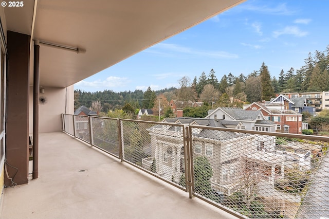 balcony featuring view of scattered trees