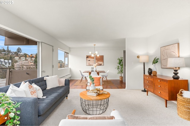 2323 SW Park Pl Unit 603, Portland, OR 97205 - carpeted living room with a chandelier and baseboards