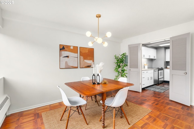 2323 SW Park Pl Unit 603, Portland, OR 97205 - dining room featuring a baseboard radiator, a chandelier, and baseboards