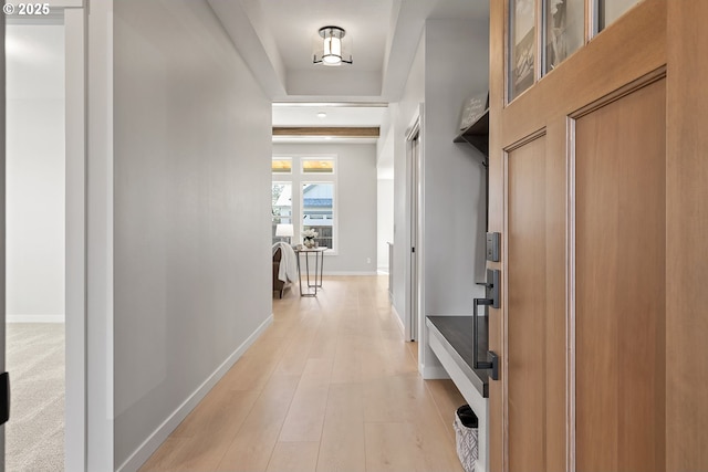 mudroom featuring baseboards and light wood-style floors