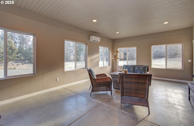 interior space with a healthy amount of sunlight and a wall unit AC