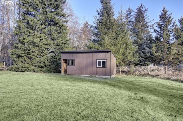 view of outbuilding with a yard