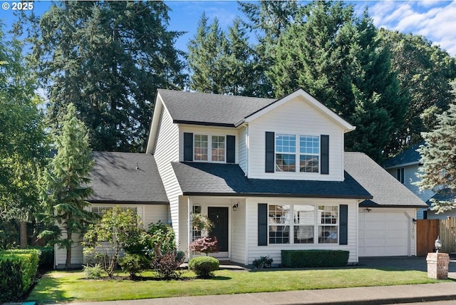 view of front of house featuring an attached garage, a shingled roof, a front lawn, and fence