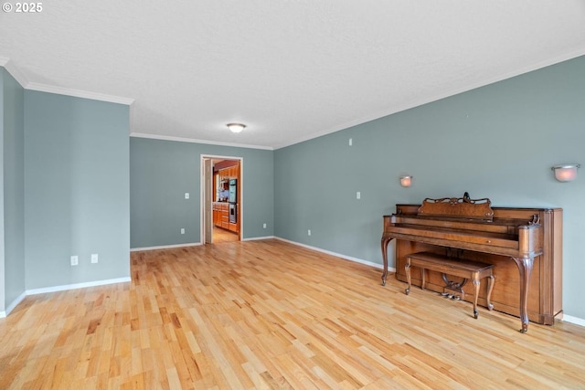 living area featuring wood finished floors, baseboards, and ornamental molding