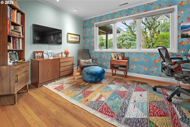 office area featuring crown molding, wood-type flooring, and a healthy amount of sunlight