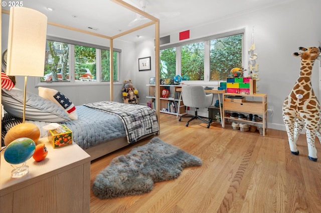 bedroom featuring light wood-type flooring and ornamental molding