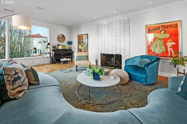 living room with a brick fireplace, ornamental molding, and wood-type flooring