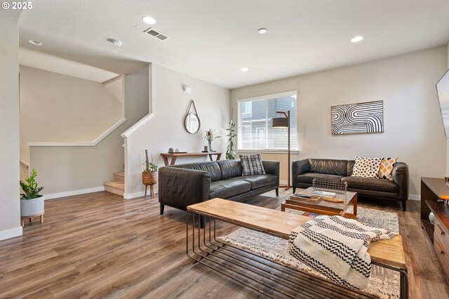 14139 SW Burlwood Ln, Beaverton, OR 97005 - living room with wood finished floors, stairway, and recessed lighting