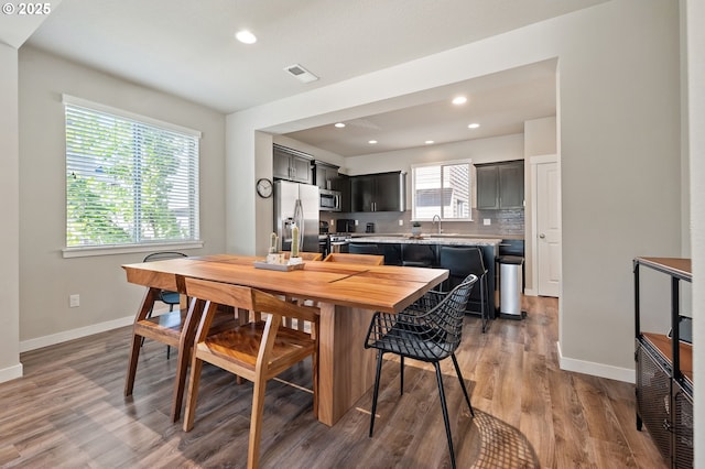 14139 SW Burlwood Ln, Beaverton, OR 97005 - dining space with light wood-style flooring and recessed lighting