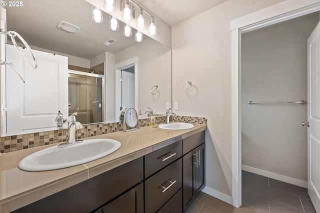 14139 SW Burlwood Ln, Beaverton, OR 97005 - bathroom with double vanity, tile patterned floors, a stall shower, and backsplash