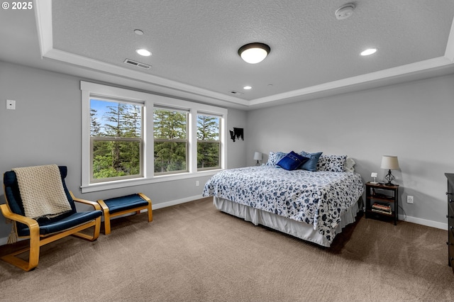carpeted bedroom with a tray ceiling, a textured ceiling, baseboards, and recessed lighting