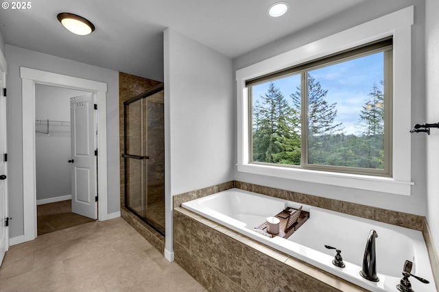 full bath featuring a shower stall, a walk in closet, a bath, recessed lighting, and tile patterned flooring