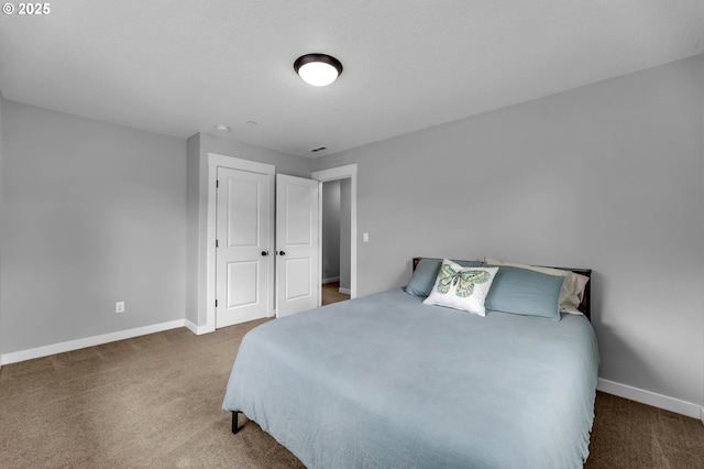 carpeted bedroom featuring baseboards