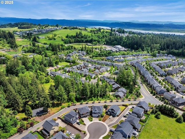 aerial view of residential area featuring a mountain backdrop
