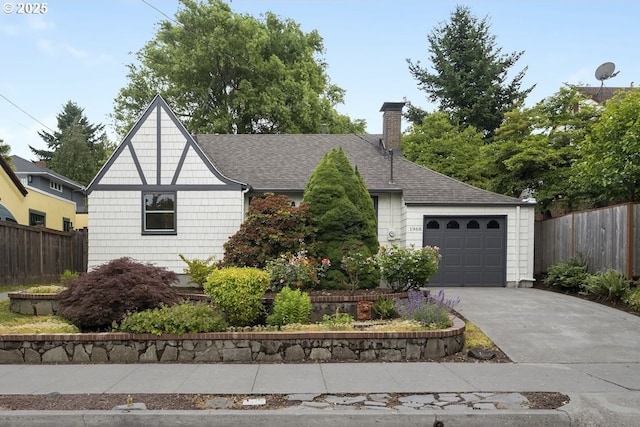 1968 SE 25th Ave, Portland, OR 97214 - view of front of home with a chimney, an attached garage, concrete driveway, and roof with shingles