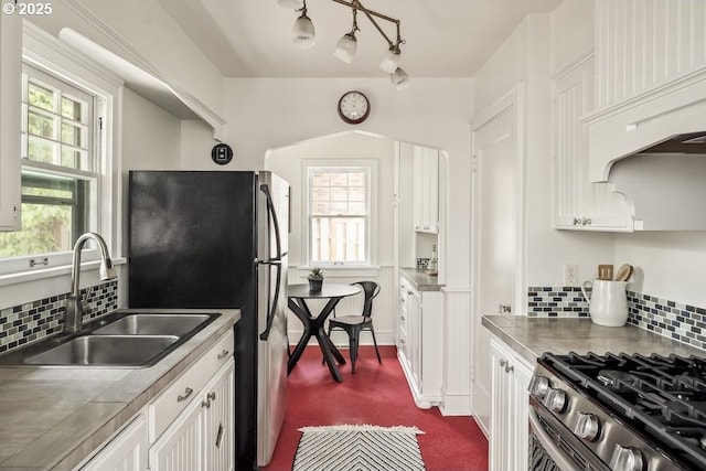 1968 SE 25th Ave, Portland, OR 97214 - kitchen featuring stainless steel appliances, white cabinets, tasteful backsplash, and plenty of natural light