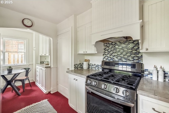 1968 SE 25th Ave, Portland, OR 97214 - kitchen featuring stainless steel range with gas cooktop, white cabinets, backsplash, stainless steel countertops, and dark colored carpet