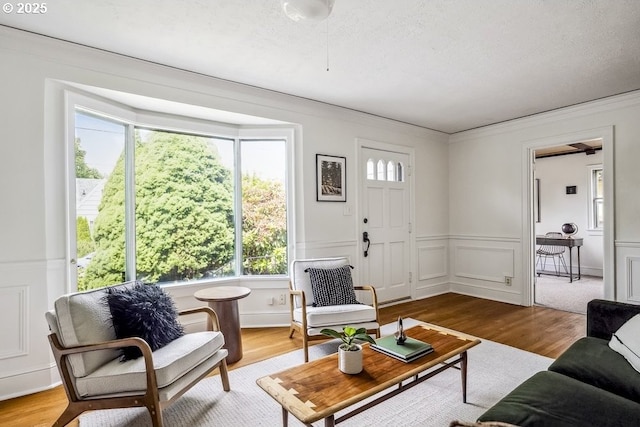 1968 SE 25th Ave, Portland, OR 97214 - living room with wood finished floors, wainscoting, ornamental molding, and a decorative wall