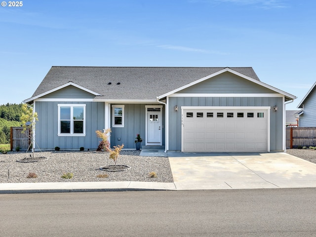 1155 SE Bugle Ave, Warrenton, OR 97146 - single story home with board and batten siding, an attached garage, concrete driveway, and a shingled roof