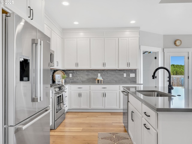 1155 SE Bugle Ave, Warrenton, OR 97146 - kitchen with stainless steel appliances, light wood-style flooring, white cabinets, and recessed lighting