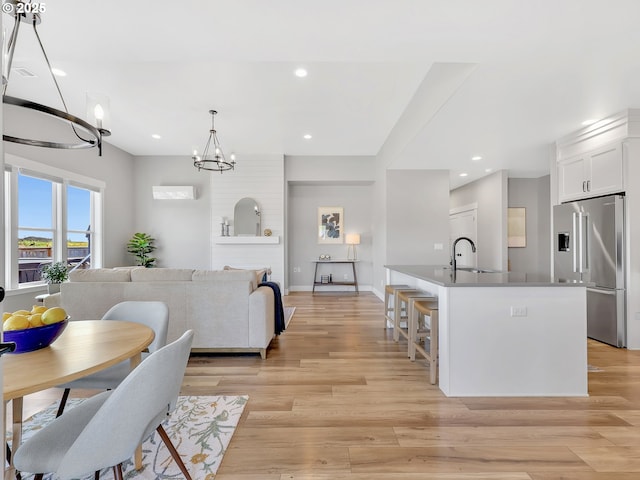 1155 SE Bugle Ave, Warrenton, OR 97146 - kitchen featuring high quality fridge, a chandelier, white cabinets, light wood finished floors, and recessed lighting