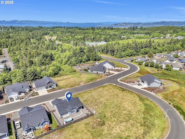 1155 SE Bugle Ave, Warrenton, OR 97146 - aerial view of residential area featuring a heavily wooded area and a mountain backdrop