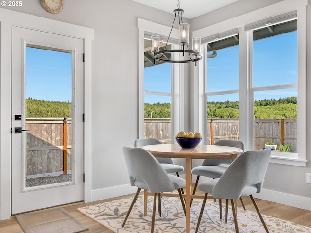 1155 SE Bugle Ave, Warrenton, OR 97146 - dining room featuring a chandelier and light wood-style floors