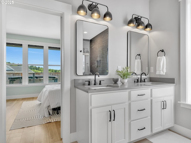 1155 SE Bugle Ave, Warrenton, OR 97146 - full bathroom featuring double vanity, wood finished floors, and a shower