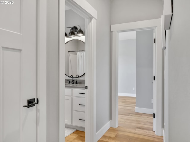 1155 SE Bugle Ave, Warrenton, OR 97146 - hallway with a sink and light wood-type flooring