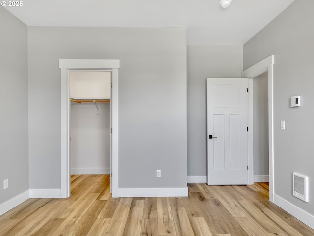 1155 SE Bugle Ave, Warrenton, OR 97146 - unfurnished bedroom featuring wood finished floors, a closet, and a spacious closet