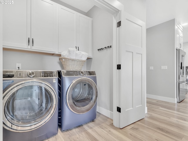 1155 SE Bugle Ave, Warrenton, OR 97146 - laundry room featuring cabinet space, separate washer and dryer, and light wood finished floors