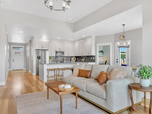 1155 SE Bugle Ave, Warrenton, OR 97146 - living room with a chandelier, light wood finished floors, and recessed lighting