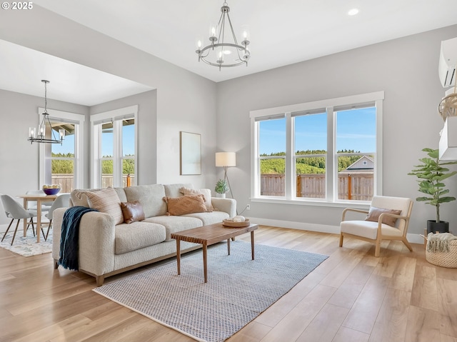 1155 SE Bugle Ave, Warrenton, OR 97146 - living area with a chandelier, light wood-type flooring, recessed lighting, and a wall mounted AC