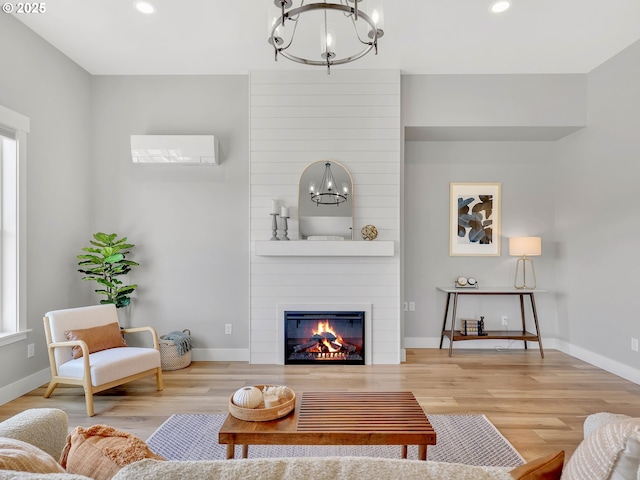 1155 SE Bugle Ave, Warrenton, OR 97146 - living room featuring a chandelier, a large fireplace, recessed lighting, and wood finished floors
