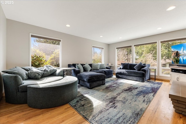 living area with recessed lighting and light wood finished floors