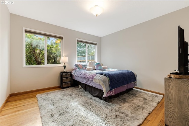 bedroom with light wood-style floors and baseboards