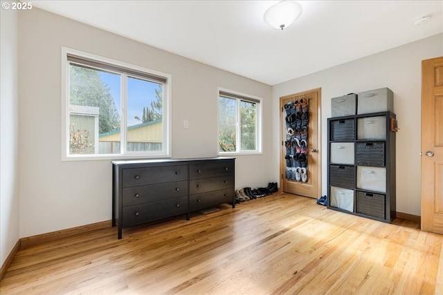 interior space featuring light wood-style flooring and baseboards