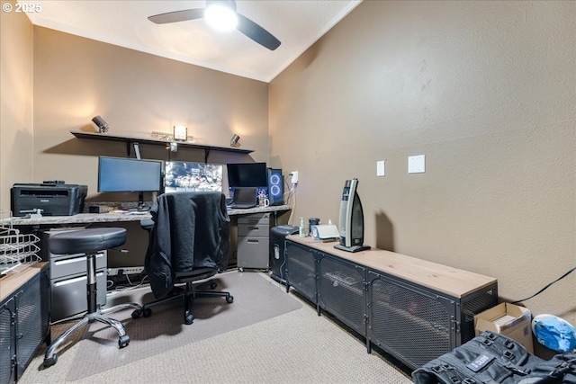 carpeted home office featuring ceiling fan, lofted ceiling, and ornamental molding