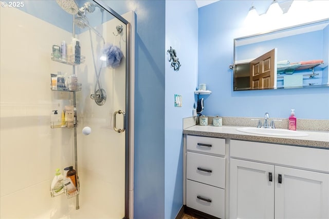 full bath with vanity and a stall shower