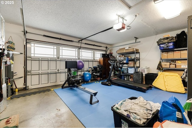 workout area with a healthy amount of sunlight, a textured ceiling, and a garage