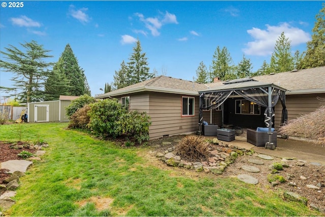 back of house with a patio, a shed, a chimney, an outdoor structure, and a lawn